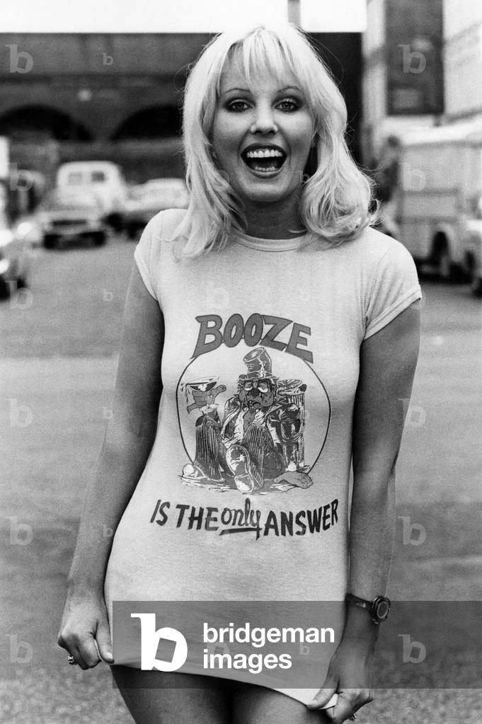 Fashion - 1970's: Tee Hee shirts. Some people will wear anything for laughs. That's why the T-shirt has become the Tee Hee shirt. For trendies with an eye to a quick sale have turned it into a top-selling giggle garment with fun designs all the rage. The man behind many of the designs is Bob Lange, 28, who runs a business with his brother in North London. He said: 