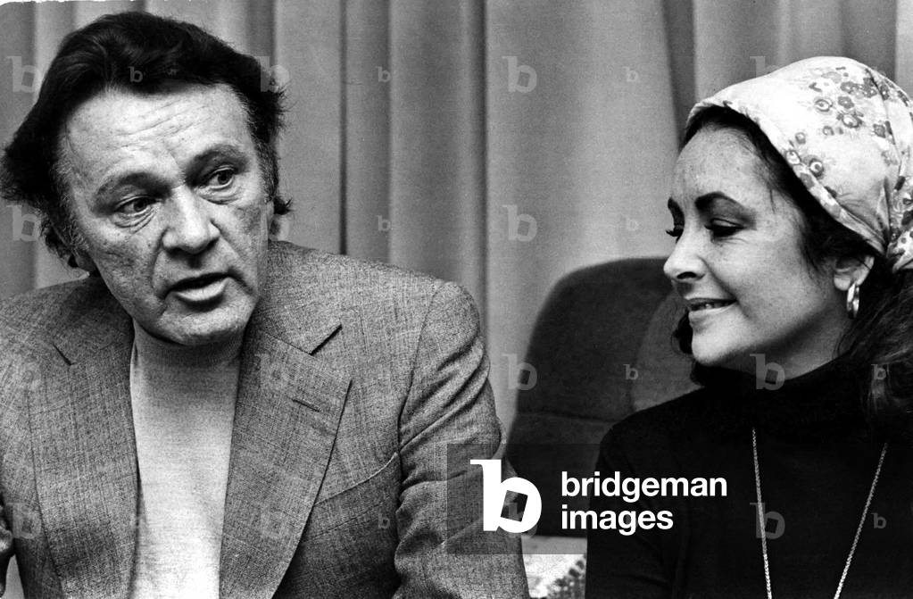 A fond look for Richard Burton from Liz Taylor yesterday as they sat and chatted in the front room of the home of his brother, David Jenkins, in Parklands View, Sketty. November 1975.