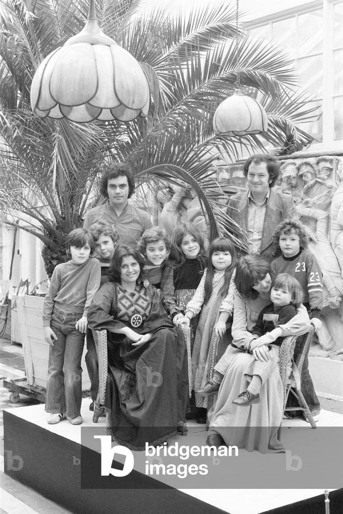 Benny Gallagher & Graham Lyle, of music group Gallagher & Lyle, pictured with their families at Shepperton Studios where they are rehearsing, 11th January 1977 (b/w photo)