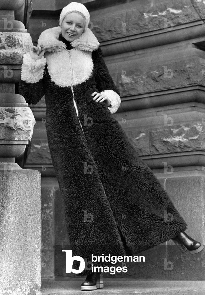 Long warm days. Winter is no time for shivering. And there is no need with a coat like this. In chocolate curly borg fabric, it is topped with whipped-cream coloured dicky-yoke, muffle-up collar and cuffs. So quick to zip on, this great coat on a cold day. Wear it with a snug, knitted wool hat, pulled down to keep ears warm. By Seasons, size 10-14, price about £30. December 1972