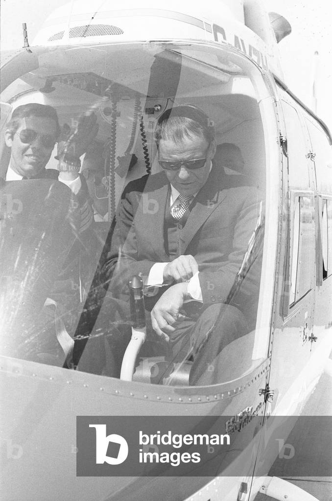 Singer Frank Sinatra who is in the United Kingdom to perform two charity concerts in aid of childrens charities. Is seen here in a Bell Jet Ranger helicopter at Gatwick Airport, shortly after arriving in his private jet. Sinatra took the short flight from Gatwick to Battersea heli-port to avoid the capitals traffic. 4th May 1970 (b/w photo)