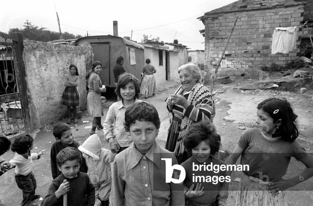 Children and residents on the streets in a poor suburb on the outskirts of Rome, Italy April 1975 (b/w photo)