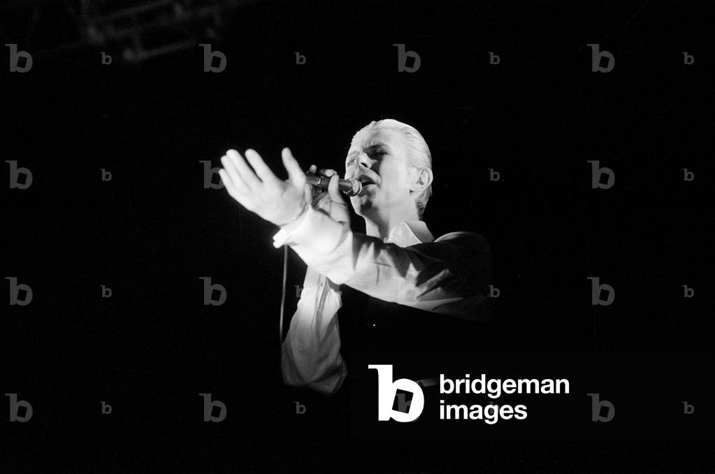 British pop singer David Bowie performing on stage during concert at Wembley, UK, 29th June 1978 (b/w photo)