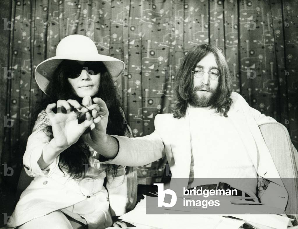 John Lennon and Yoko Ono at London airport presenting acorns they intend sending to heads of state throughout the world requesting them to plant for peace 
April 1969