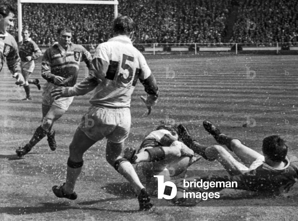 Leeds v Wakefield Rugby League Cup Final 11th May 1968. Smith of Leeds on his back as Batty of Wakefield Trinity (5) looks on.
