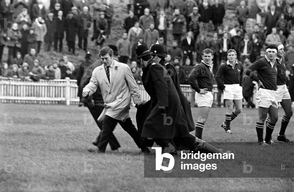 Sport Rugby Union. East Midlands v South Africa. Demonstration against the Springbok visit and apartheid policy. For this demonstrator the game is over. He reached the pitch, but his appearance was brief. Now the waiting Springbok can carry on playing. November 1969