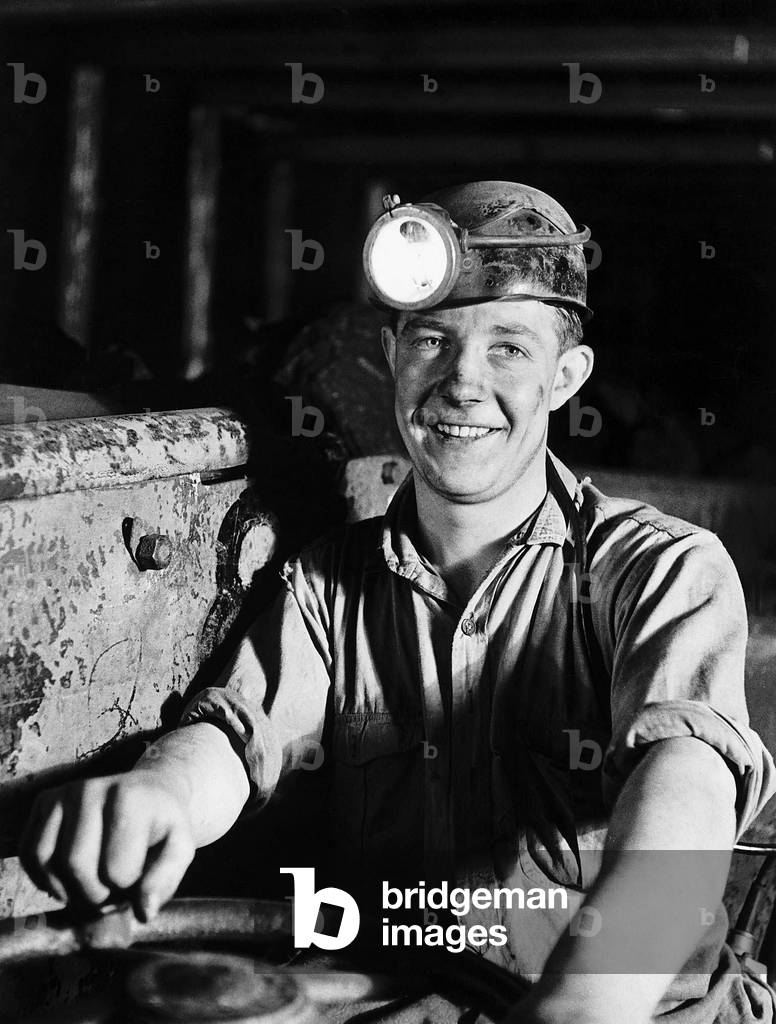Coal Miner James Turner from Newcastle who drives an electric shuttle car down the mine, 1947 (b/w photo)