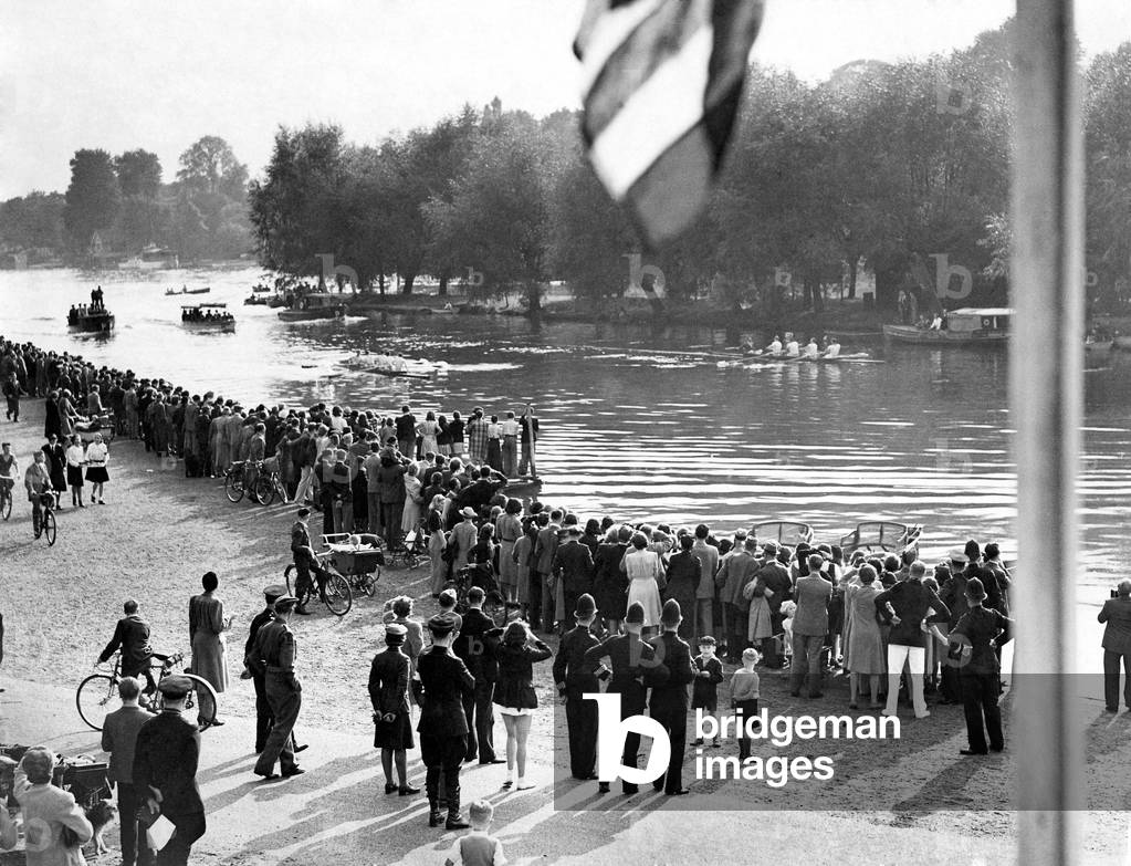 Rowing, crowds gather on the banks of the Thames to see the U.S Army Air Force rowing team compete against the Met Police Athletic Association. The Met police finish winners. September 1942