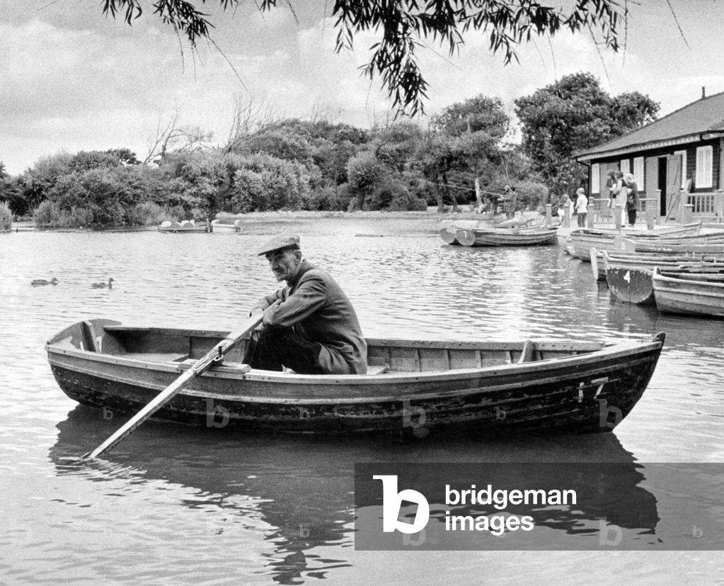 Taking a well earned rest after a busy season is Redcar boating lake attendant Joe Lloyd, aged 64, Locke Park, Redcar, 11th September 1972 (b/w photo)