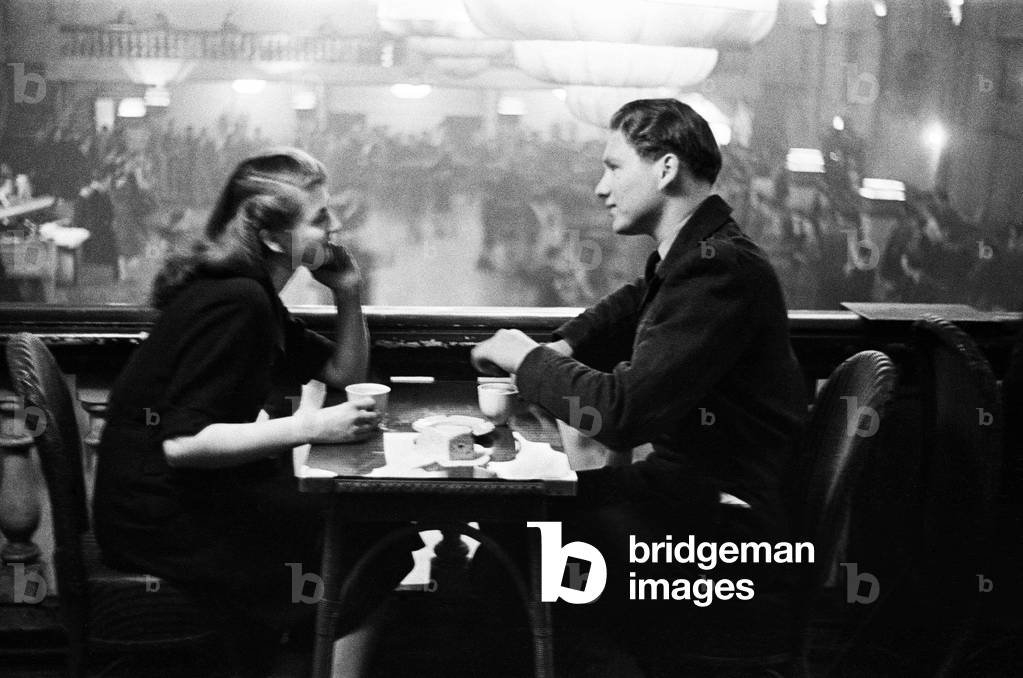 Saturday night dancing at Hammersmith Palais. Young couple enjoy a quiet moment away from the dance floor with cups of tea., c. 1947 (b/w photo)