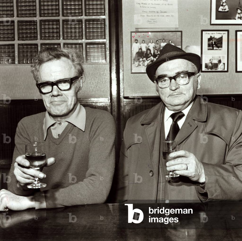 Two men enjoying a drink in their local pub, 16th April 1975 (b/w photo)