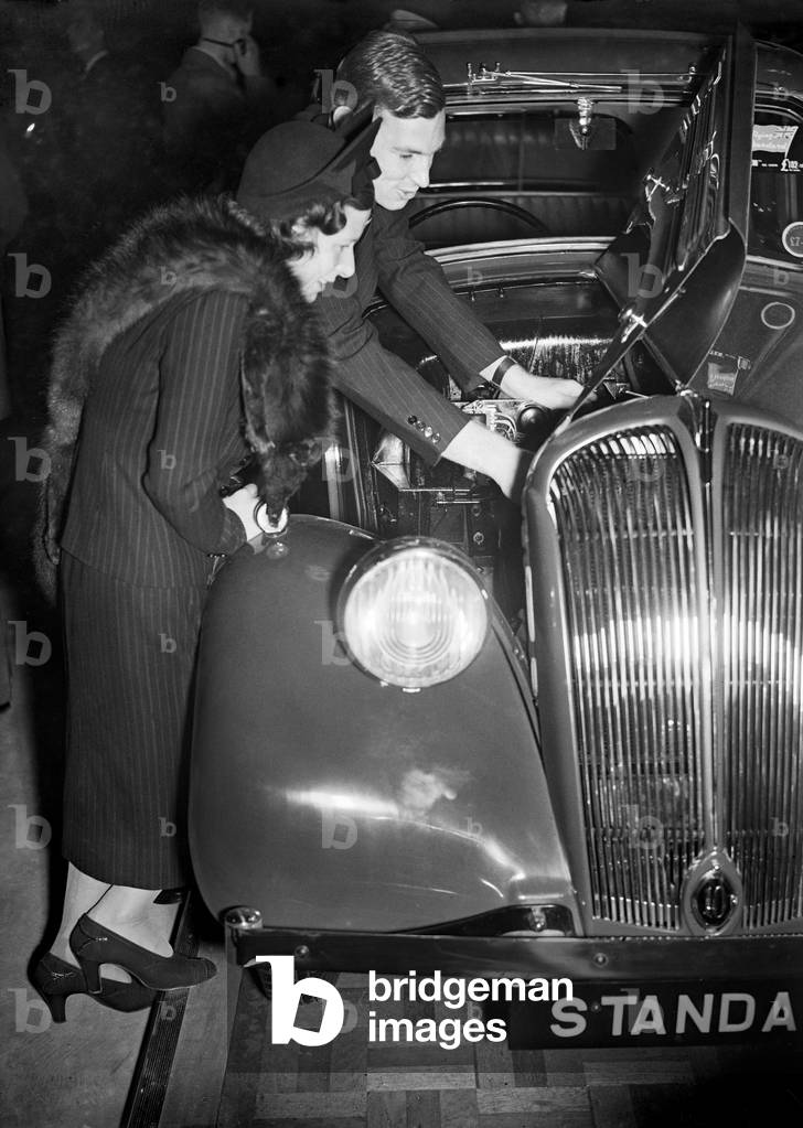The British International Motor Show held at Earls Court, London held from the 14th to the 23rd October 1937. Mrs Hall and Standard at the exhibition. 14th October 1937 (b/w photo)