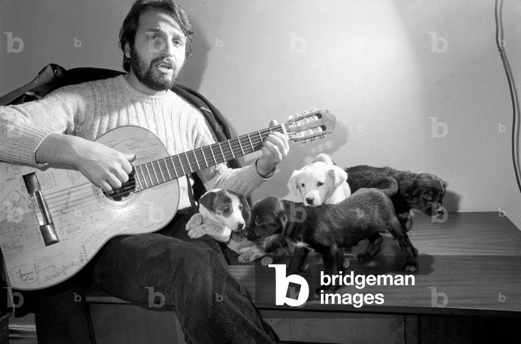 Salvatore Sangiorgi Italian singer and guitarist seen here at the RSPCA Home and Clinic Trenmare Gardens, London, singing to a pair of abandoned dogs December 1969