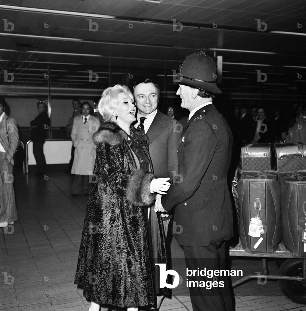 Zsa Zsa Gabor and her new husband inventor Jack Ryan arrived at Heathrow airport from Tokyo, April 1975 (b/w photo)