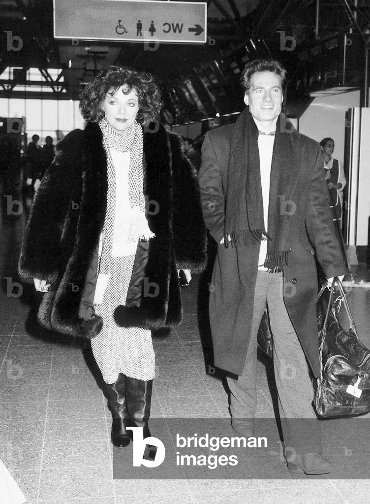 Joan Collins the actress with actor Neil Dickinson on their way to Los Angeles in January 1988.