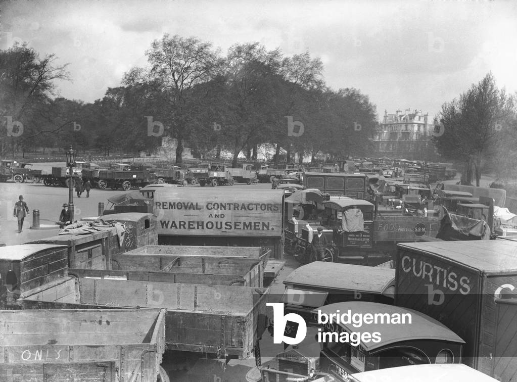 Food transport lorries parked up in Hyde Park on the tenth day of the General Strike. Hyde Park was closed for the duration of the strike and was rapidly transformed into great milk and petrol dump The national dispute came about after negotiations between the miners and mine owners failed over wages and a lock out, the strike began on 3 May 1926. Millions obeyed the strike call, bringing transport systems to a halt while newspapers were not printed. The government responding by using volunteers to run trains and buses and sent in troops to move supplies from the London docks. There were clashes between police and crowds in many areas and at least 4000 strikers were arrested. There were attacks on buses and trains, including the derailing of the Flying Scotsman. The strike was called off unilaterally by the TUC on 12 May with no guarantees of fair treatment for the miners who fought on to bitter defeat in October. 12th May 1926 (b/w photo)