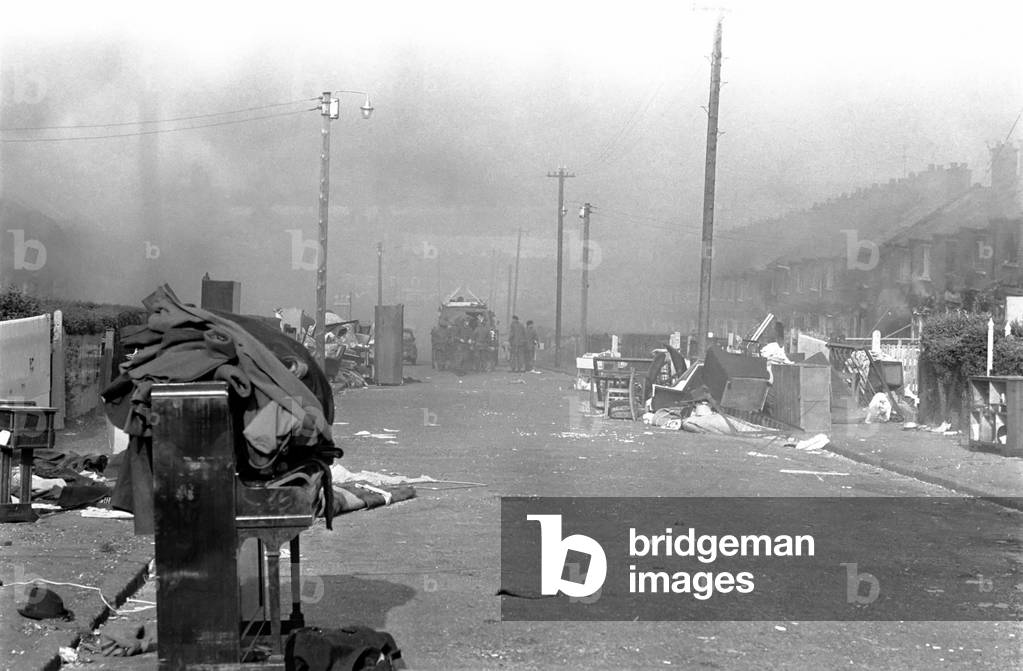 Northern Ireland Belfast Riots August 1971. The army tries to cope with rioting on the streets of Belfast as cars and shops are set alight distress members of the community look to the soldiers for protection. August 1971 71-7427-003
