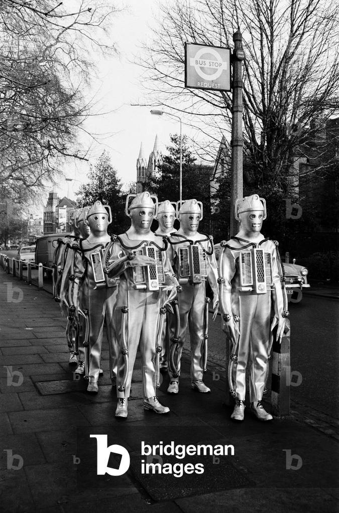 Doctor Who 1967 BBC TV Programme. The story features the return of the Cybermen in episodes titled The Moonbase, first broadcast 11th February to 4th March 1967. Pictured hailing a bus, outside Television Studios, Ealing, 19th January 1967 (b/w photo)