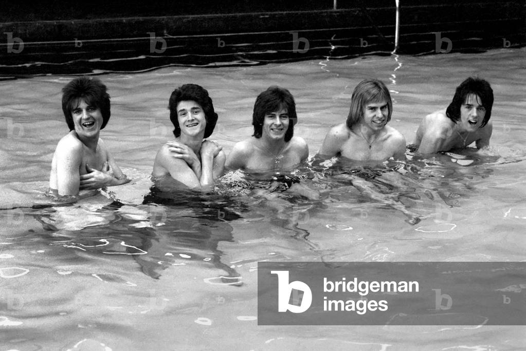 The Bay City Rollers celebrate their chart success with a quick dip in the pool, 11th March 1975 (b/w photo)