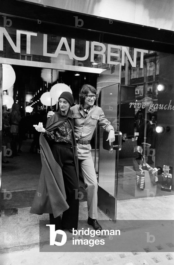 Yves Saint Laurent, designer pictured with muse Louise de La Falaise, aka Loulou, outside his first London Rive Gauche store on New Bond Street, London, opening day of boutique, 10th September 1969 (b/w photo)