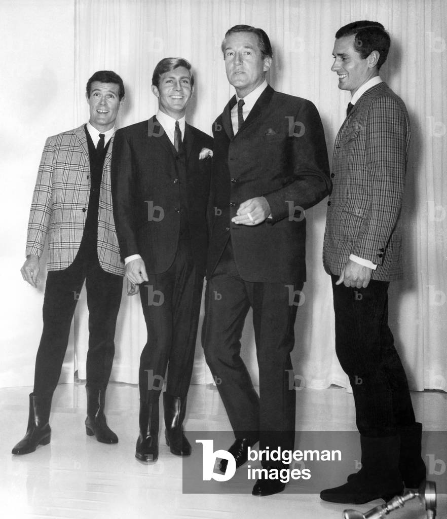 Clothing: Fashion: Menswear Suits: Hardy Amies with cigarette, with some of his 1966 models. September 1965 (b/w photo)
