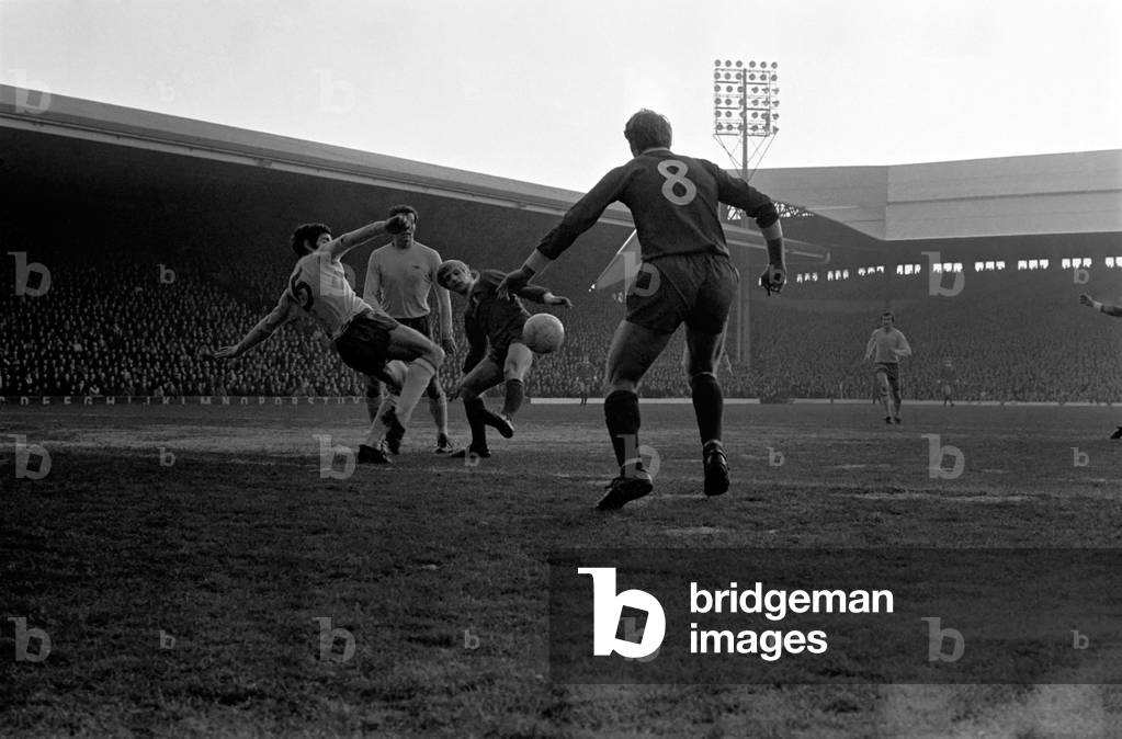 Sport: Football: Liverpool v Arsenal. Evans being challenged by McLintock miskicks in front of Arsenal goal-mouth. December 1969 (photo)