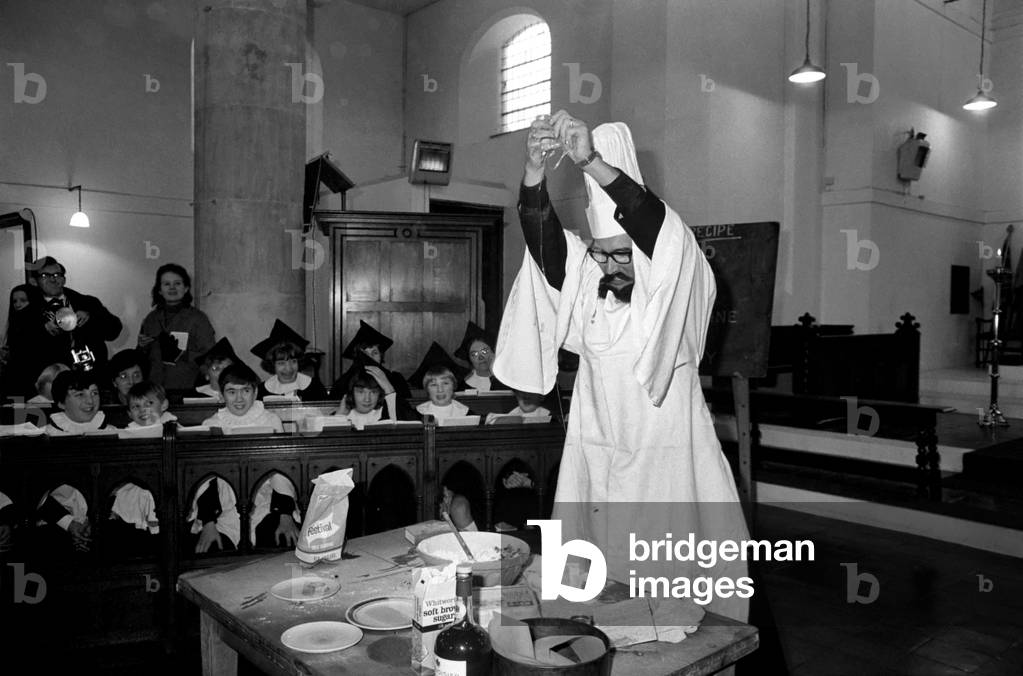 A vicar made a cake in church today to celebrate Advent traditionally the first day in the church's year. The vicar the Rev. John Harvey donned a chef's hat and a French type moustache and beard, spoke in a French accent and made the birthday cake in front of a packed congregation, in the St. Barnabas Church, Bromley, Kent. The Rev. John Harvey making his cake today. November 1969