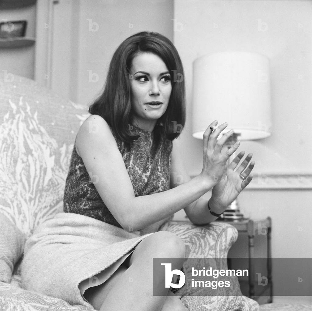 Parisienne actress Claudine Auger who will play Domino in the James Bond film Thunderball, seen here during an interview with the Daily Mirror show business reporter Donald Zec. 17th February 1965 (b/w photo)