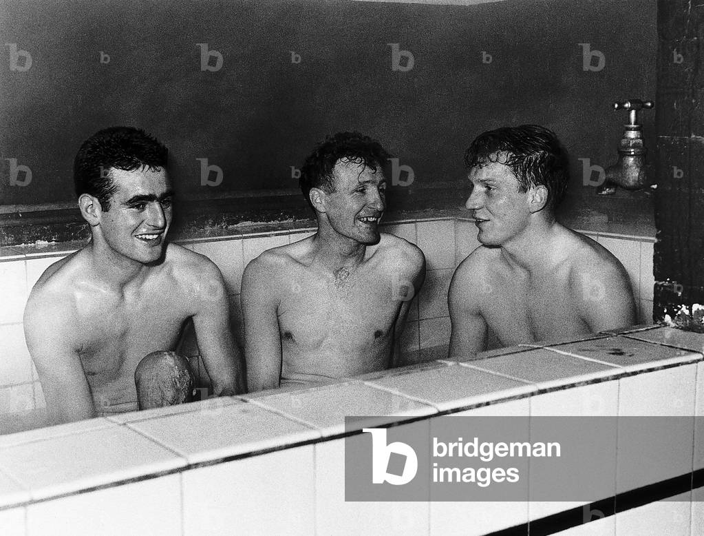 Tony Devreux, Gordon Henry & Dick Renwick of Aldershot FCenjoy a good hot bath after a hard day's training in preparation for a FA Cup tie (photo)
