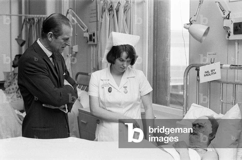 Prince Philip, Duke of Edinburgh, visits victims of the Birmingham Pub Bombings at Birmingham General Hospital., 25th November 1974 (b/w photo)