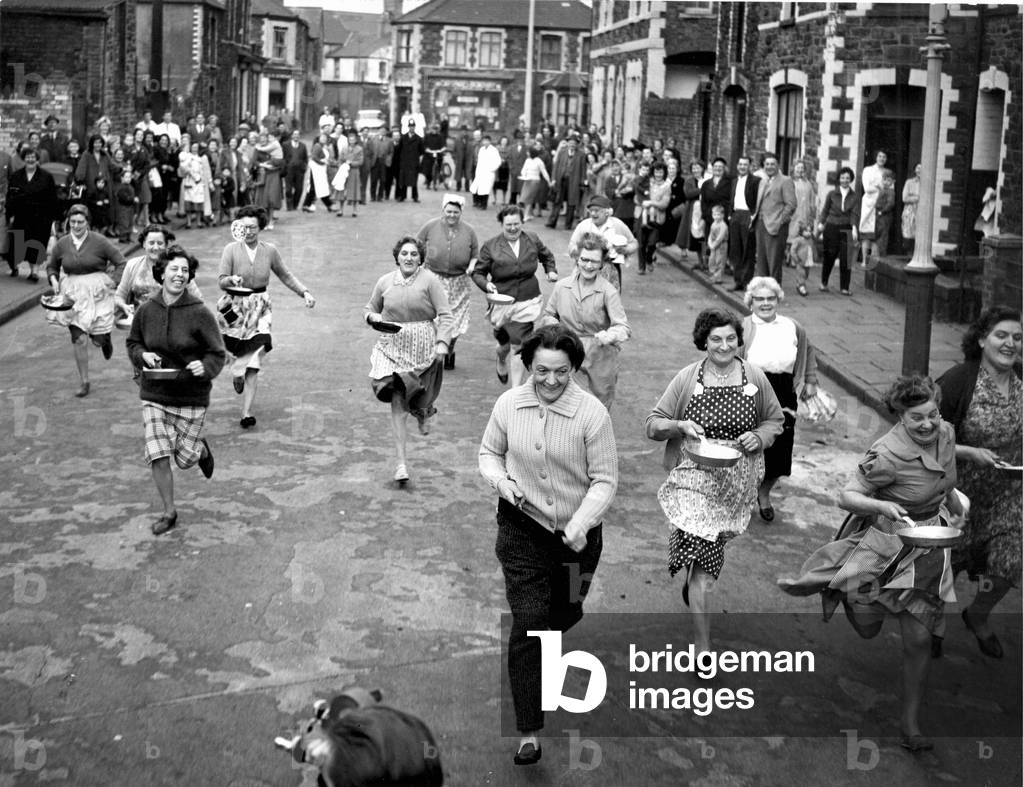 Pancake Day in Cardiff - A pancake race organised by the St Agnes Women Fellowship in aid of Congo Relief was held at Bertram Road, Roath, Cardiff. Picture shows the over 40's race, 15th February 1961 (b/w photo)