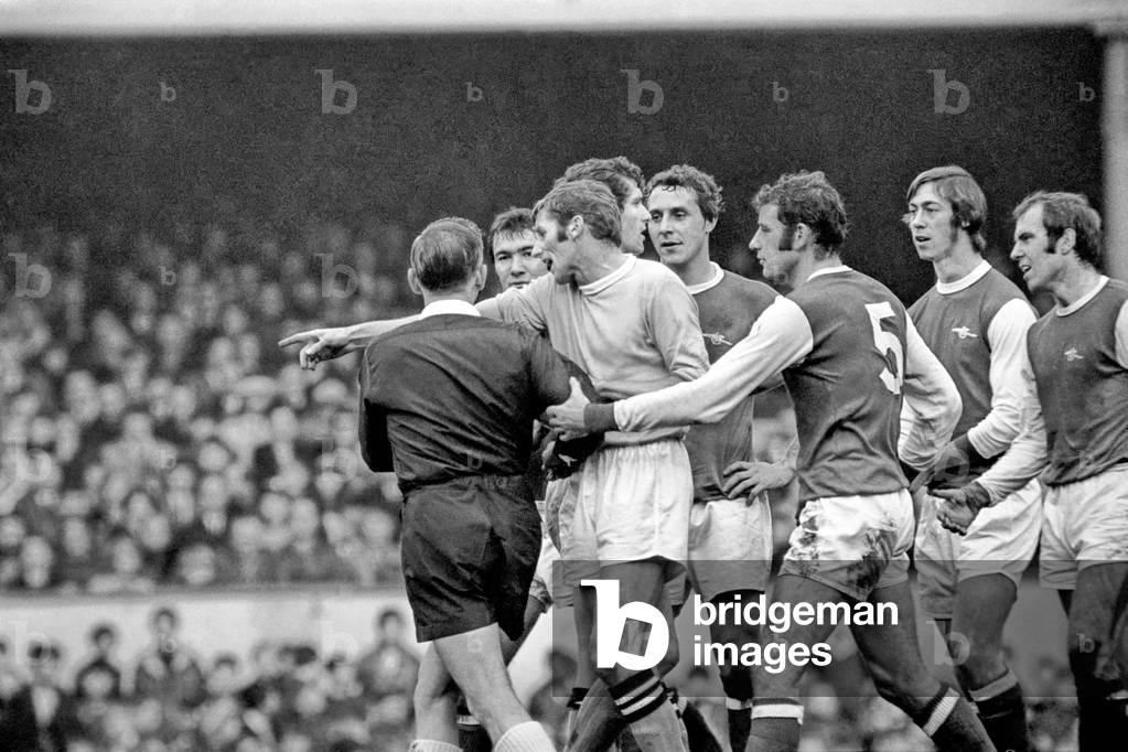 Arsenal v. Manchester City. Tony Book pointing City's captain appeals on behalf of Arsenal George after refree Wallace had booked George for substituting before he was given permission. December 1969 (photo)