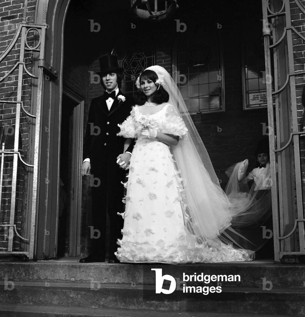 Hit song writer Graham Gouldman who has produced top ten numbers for The Hollies, Herman's Hermits and the Yardbirds, was married yesterday to Miss Susan Gottlieb, a jeweller's daughter, in Mancherster. 
The couple are seen leaving the Holy Law Synogogue at Prestwich after the ceremony. 
November 1969
