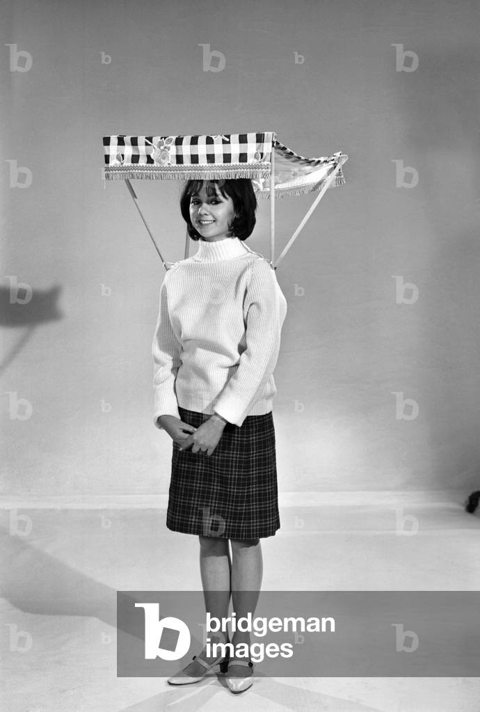 Therese Howard Jones demonstrating the wear-me umbrella. Model, c. 1959 (b/w photo)