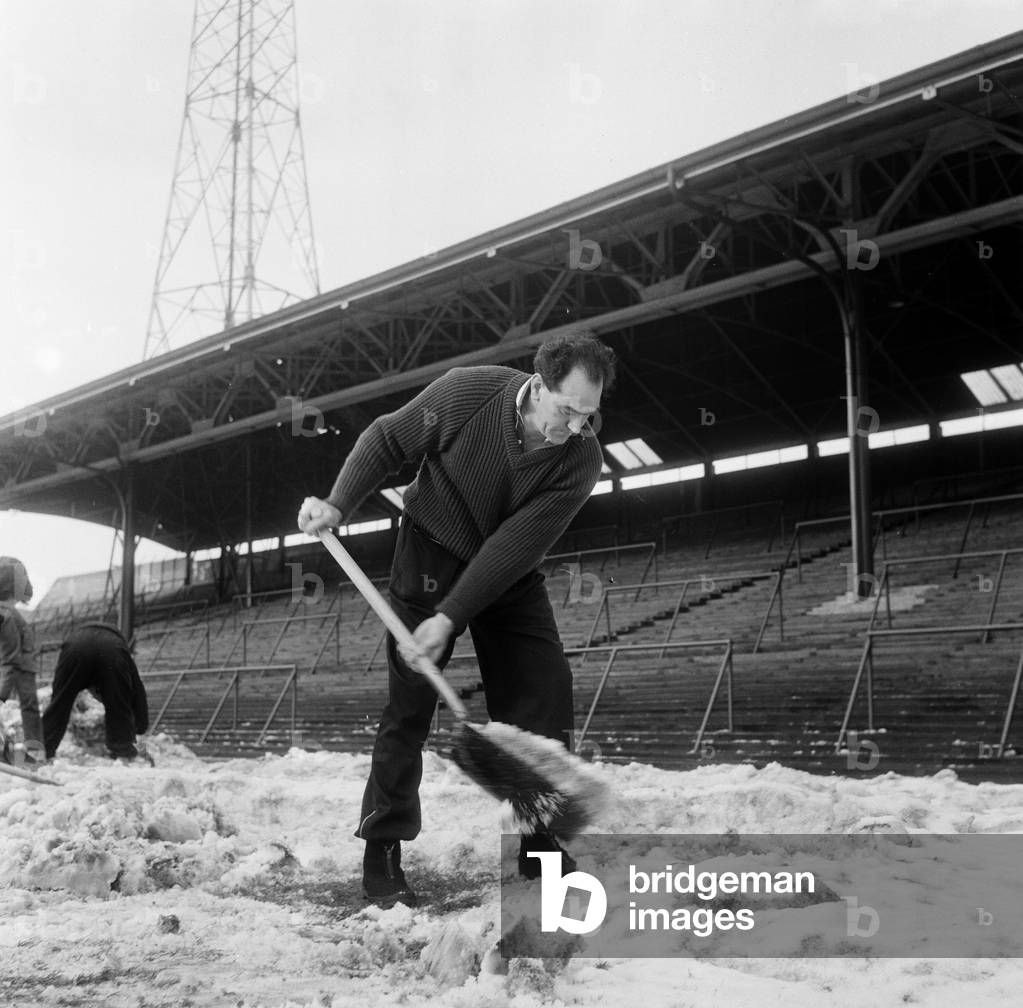 Manager Joe Harvey and players, clear snow from pitch at St James Park, home of Newcastle United Football Club. 1st February 1963 (photo)