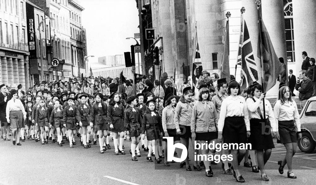 Coventry Guides and Brownies enter Broadgate, Coventry, on the way to their Thinking Day service at Coventry Cathedral, 24th February 1974 (b/w photo)