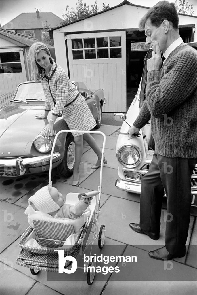 Models pose for a Lolly Dolly wives feature in Manchester. Man and woman and child in a suburban neighbourhood. November 1969