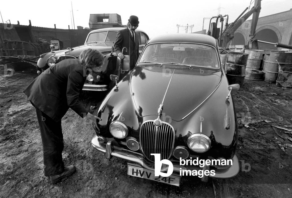 Man Scraps Jaguar Car: On the other hand, Sales Director Mr. Graham Parkes, who says he can no longer afford to run his 15 mile per gallon Jaguar, and was disgusted at dealers' offers, decided to watch its destruction, February 1975