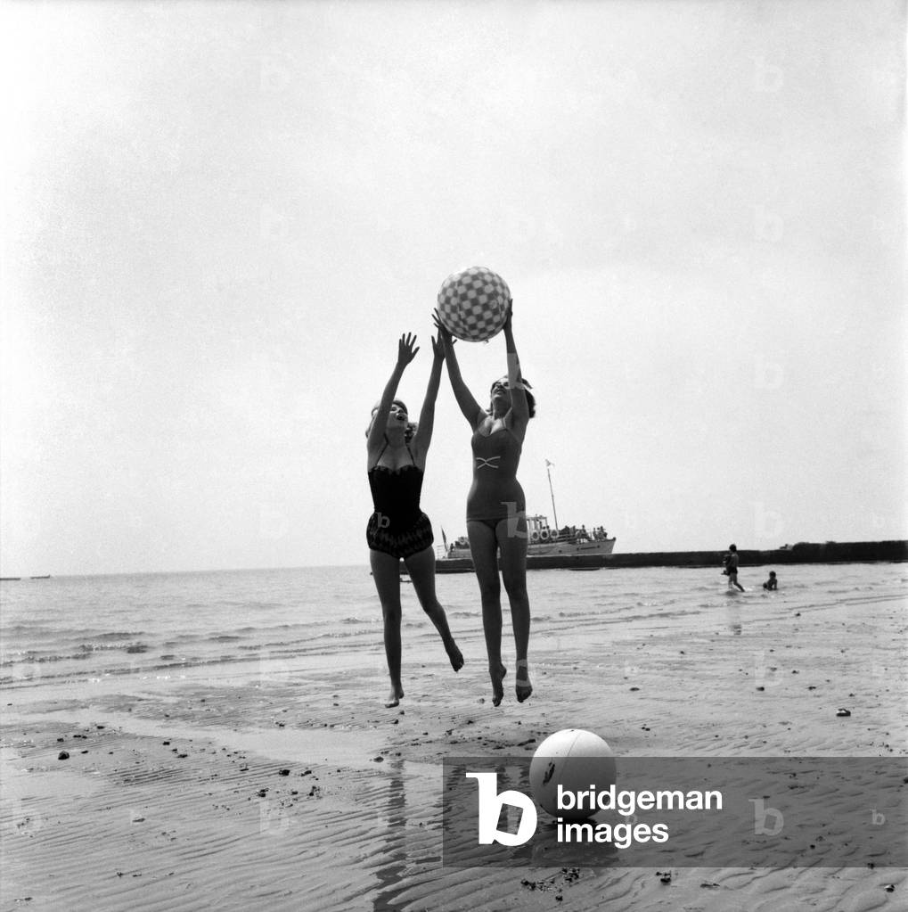 Bathing Girl: Glamour on the Clacton Beach: Kay Garton and Christine Reynolds playing water ball. June 1960