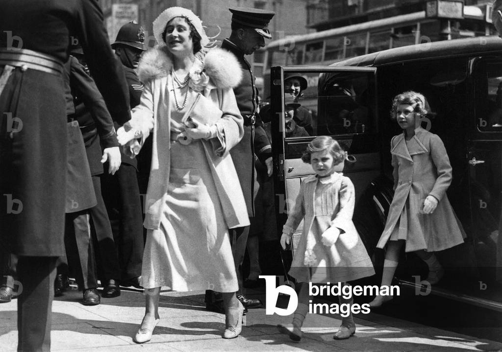 Queen Elizabeth arrives at the Royal Tournament at Olympia, with her daughters Princess Elizabeth and Princess Margaret. 
Circa 1933
