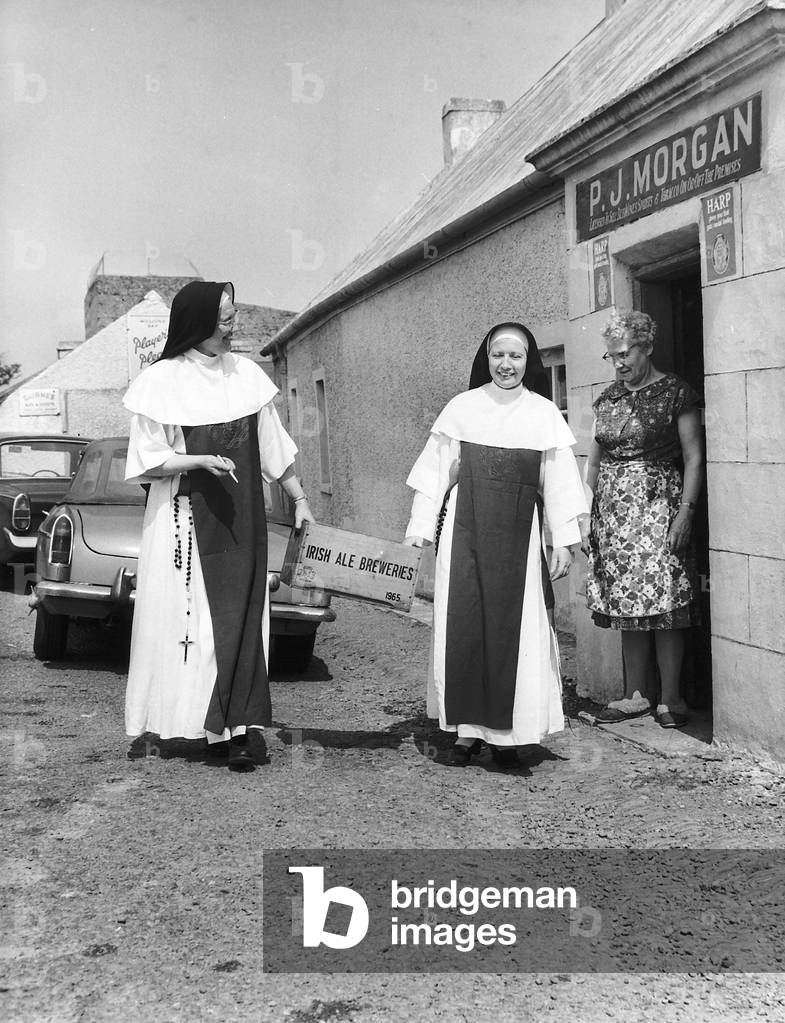 Nuns who are also barmaids in the pub that their mother owns, 14th January 1967 (b/w photo)