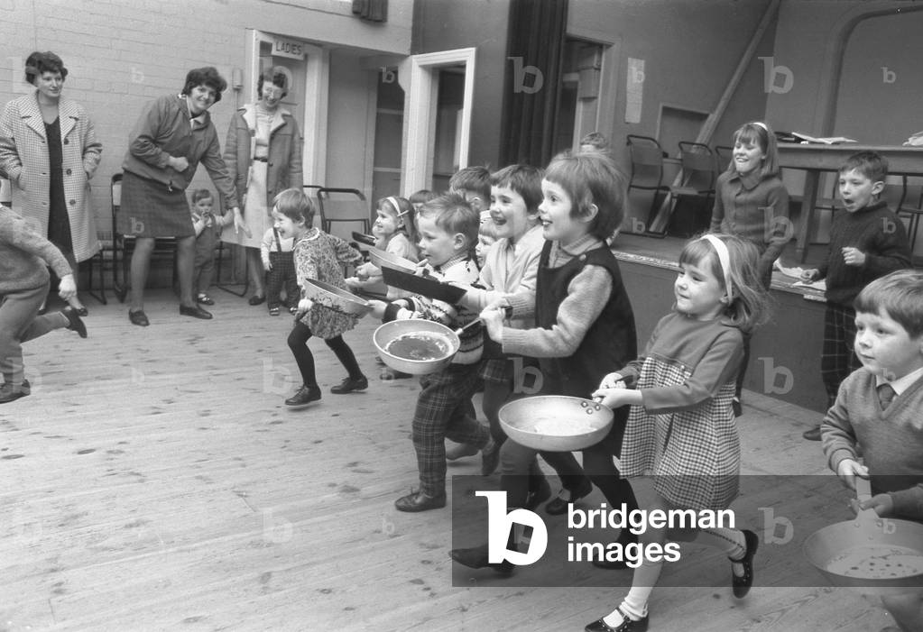 Youngsters take part in a pancake race at Styvechale Young Wives Club in Coventry. 27th February 1968 (b/w photo)
