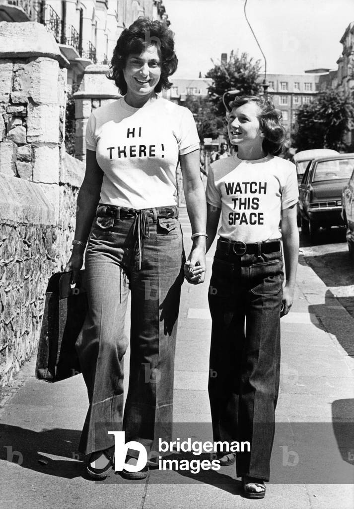 Women walking down the street wearing t shirts with amusing slogans
August 1976