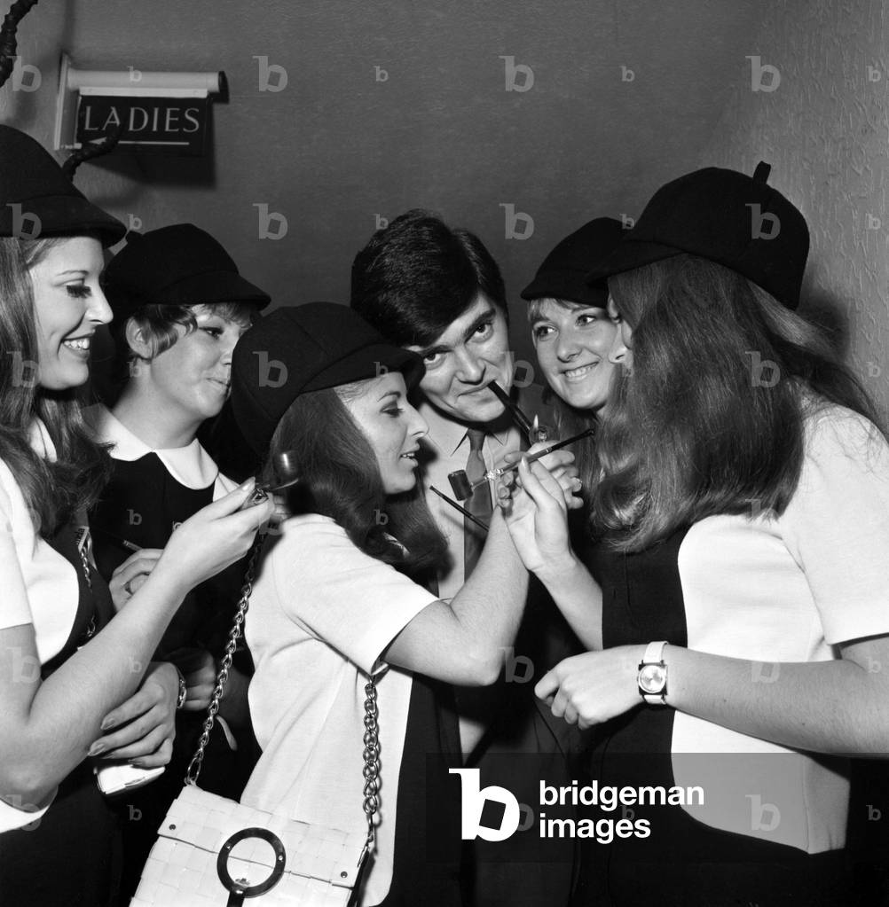 A group of fire women smoking pipes down the local pub. 
November 1969