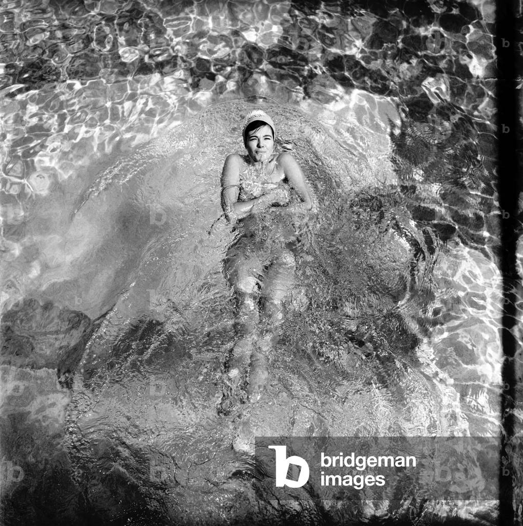Judy Roberts who has an unusual job she is a swimming costume tester, seen here at work at the local lido, June 1962 (b/w photo)