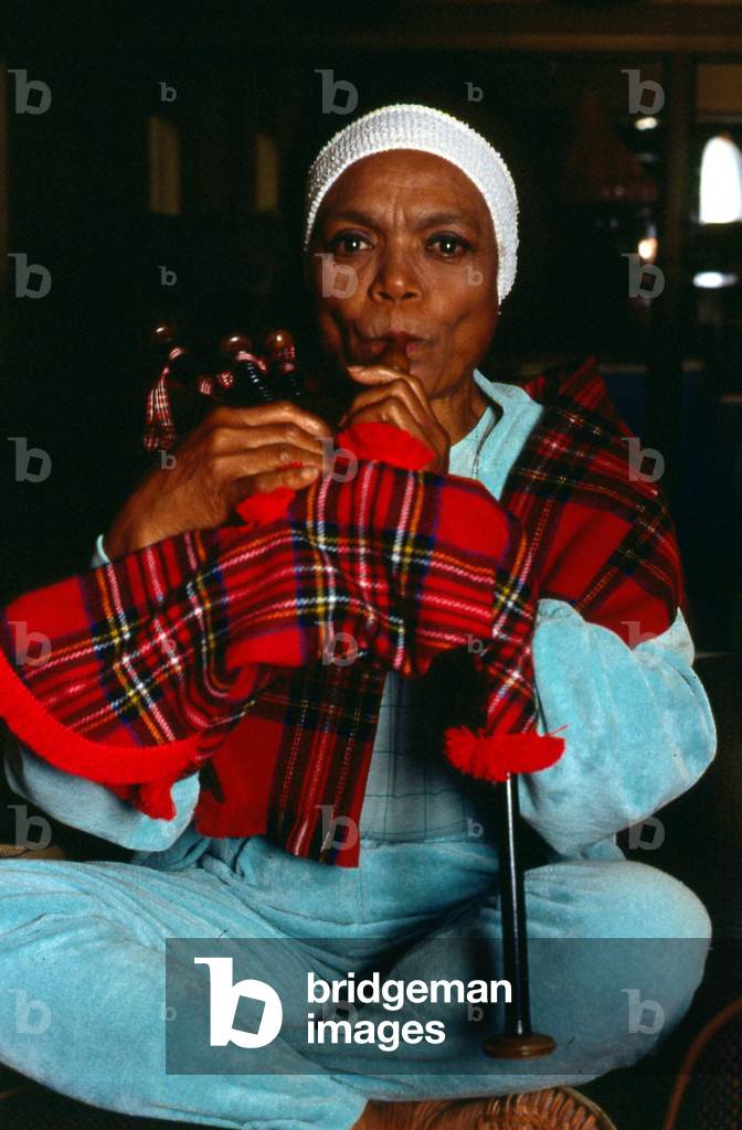 American singer and actress Eartha Kitt blowing into bagpipes November 1989 (photo)