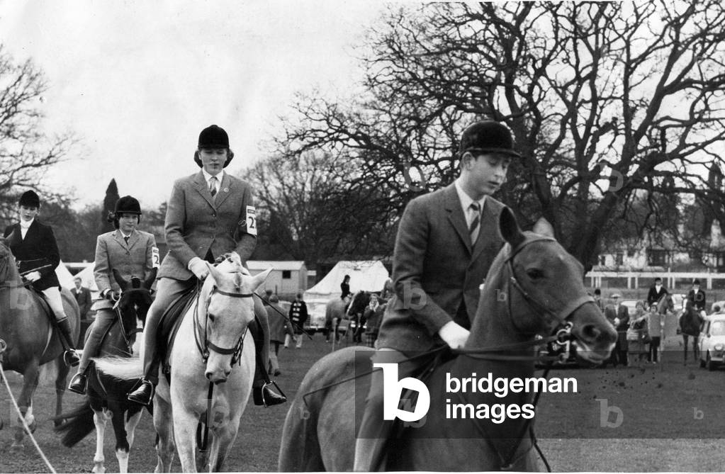 Prince Charles - The Prince of Wales leads his sister Princess Anne into the parade ring at the Ascot Gymkhana, c. 15 April 1963 (b/w photo)