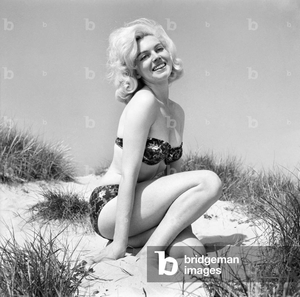Glamour girls Marion and Jean Collins on the beach. June 1960