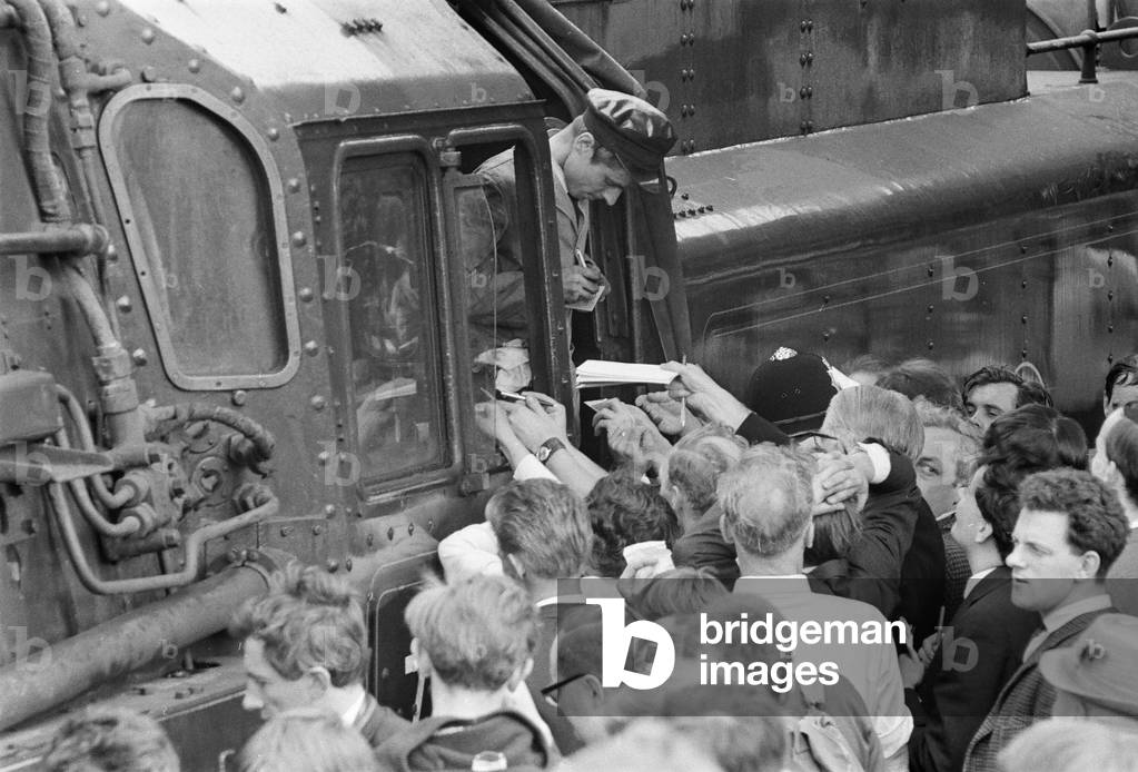 Britain's last steam locomotive passenger service. The Stanier engine 'Oliver Cromwell' Liverpool to Carlisle via Manchester. Fireman Brian Bradley signs autographs, 14th August 1968 (b/w photo)
