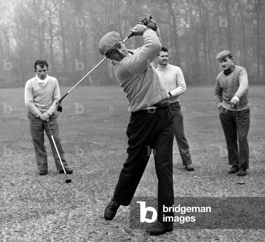 Roy Gratrix driving down the fairway on the Fairhaven Golf Links watched by Arthur Kaye and Jackie Wright when the Blackpool players played a friendly game today. January 1960 (photo)
